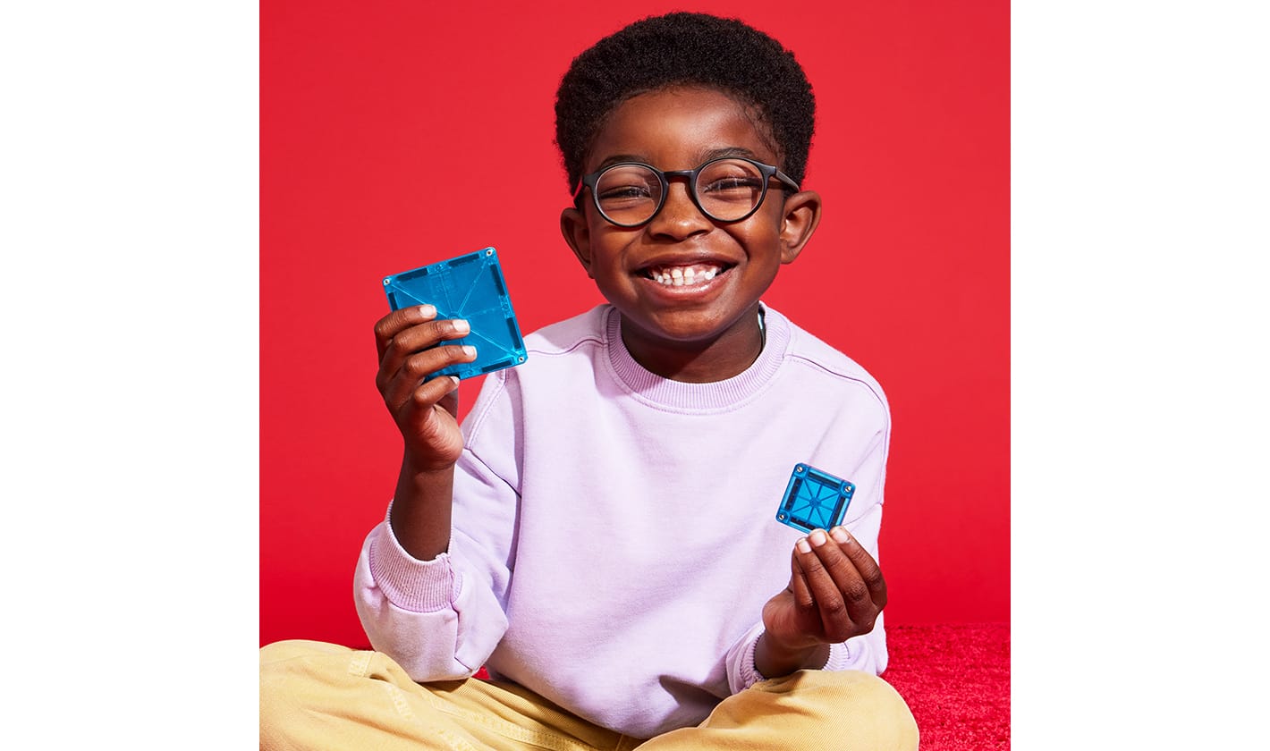 A child playing with a MAGNA-TILES® and microMAGS Combo