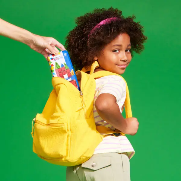 microMAGS travel set being placed in child's backpack